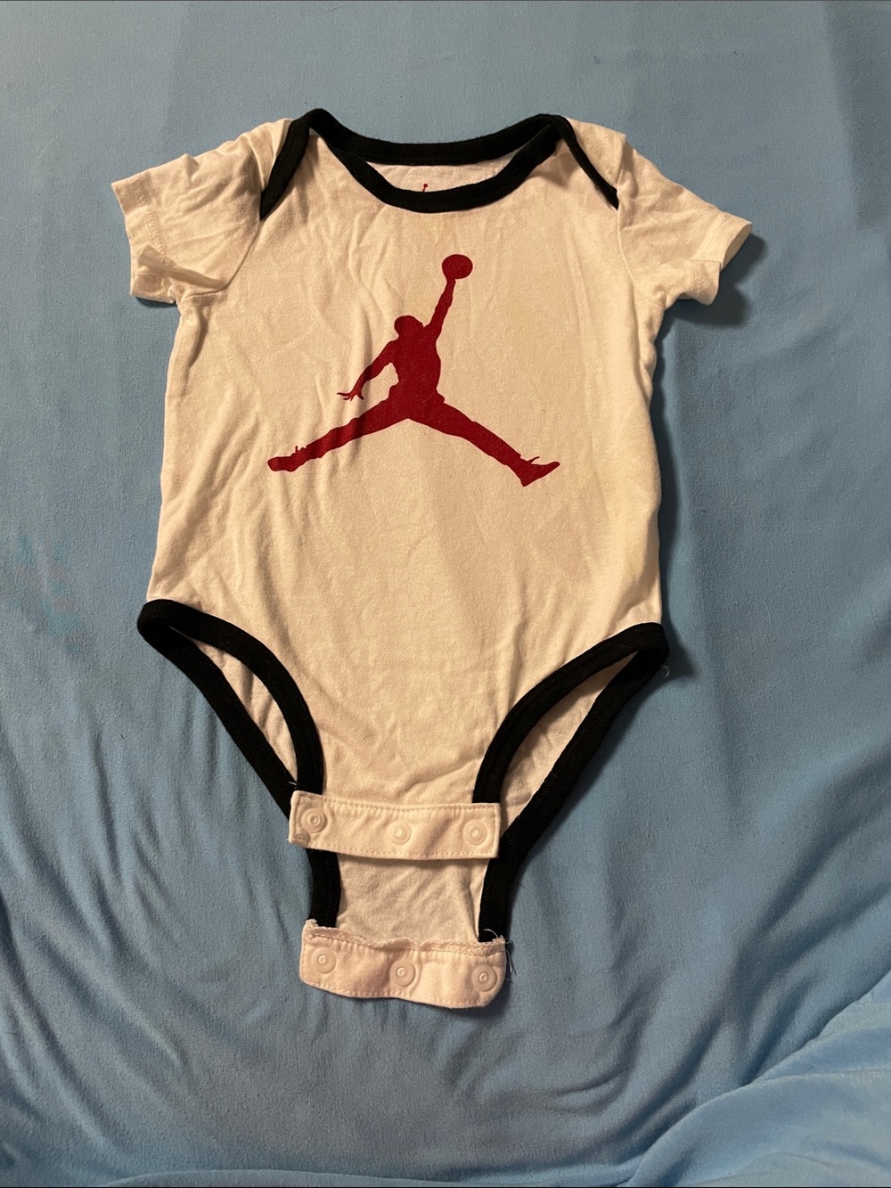 Jordan White Baby One-Piece with Black Trim and Red Jumpman